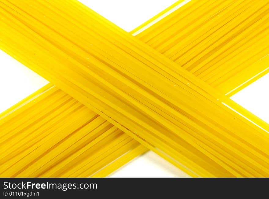 A photograph of dried spaghetti against a white background. A photograph of dried spaghetti against a white background