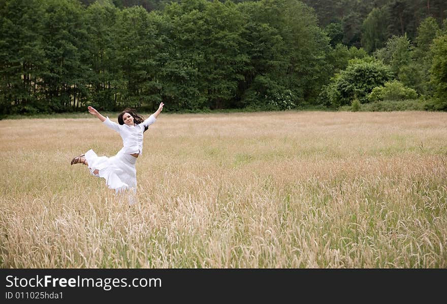 Attractive brunette woman relaxing on meadow. Attractive brunette woman relaxing on meadow