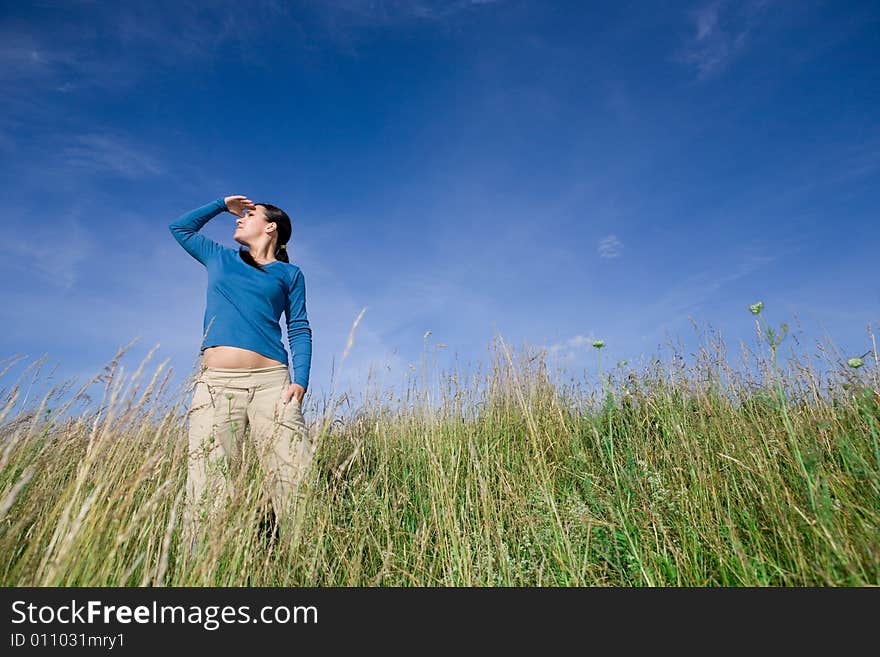 Attractive brunette woman relaxing on meadow. Attractive brunette woman relaxing on meadow