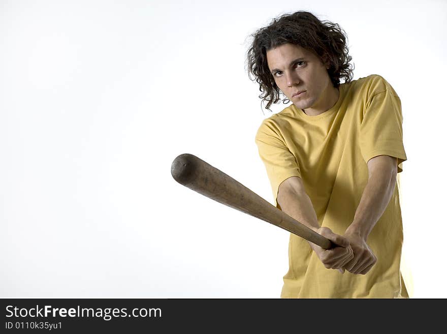 Man holding a baseball bat wearing a very serious expression on his face. Horizontally framed photograph. Man holding a baseball bat wearing a very serious expression on his face. Horizontally framed photograph