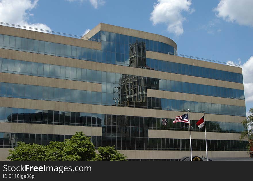 Glass building with a reflection of another builidng. Taken in Asheville North Carolina