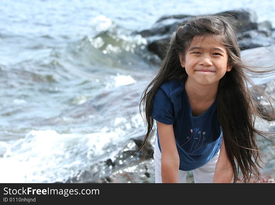 CHild playing by lake shore