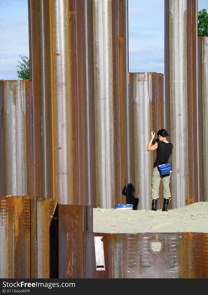 Girl taking pictures of metal girders