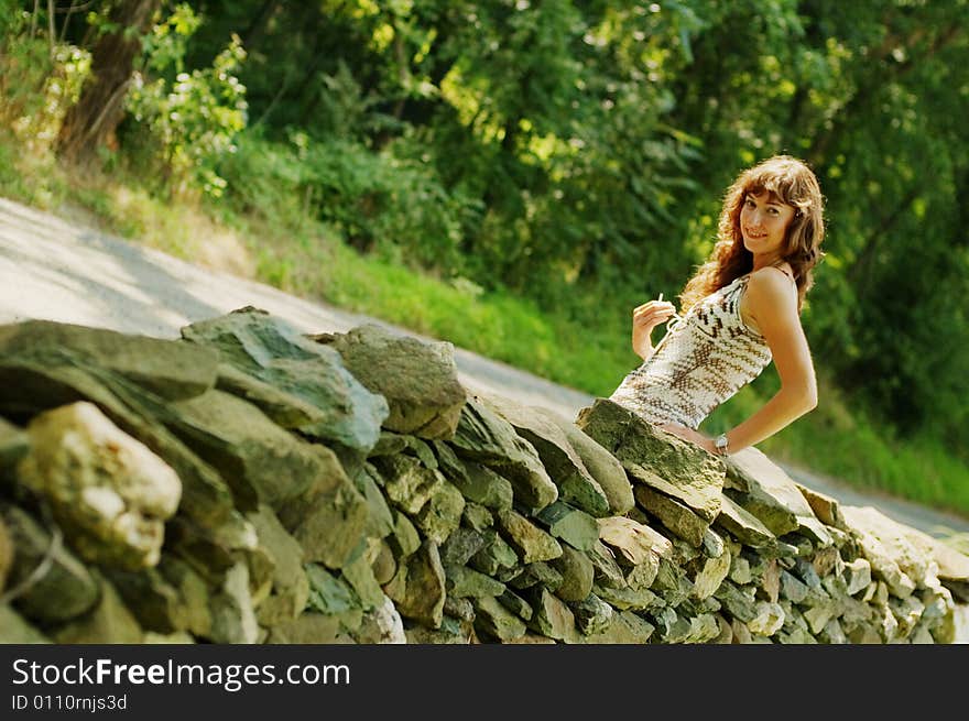 Pretty Girl Next to Stone Fence