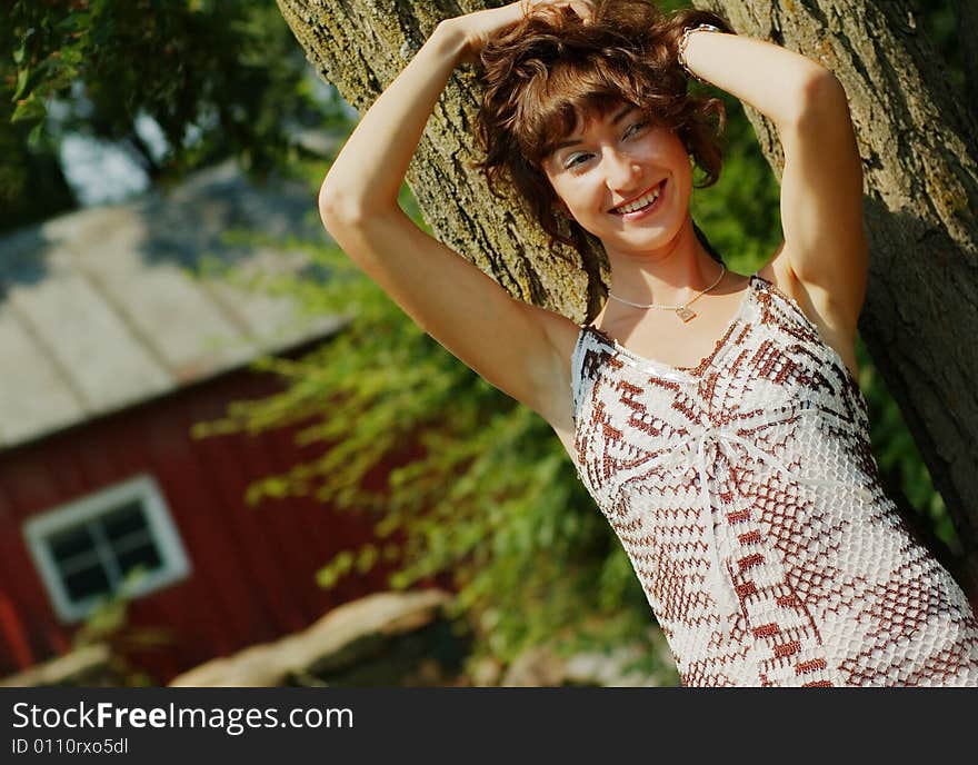 Girl Leaning Against Tree