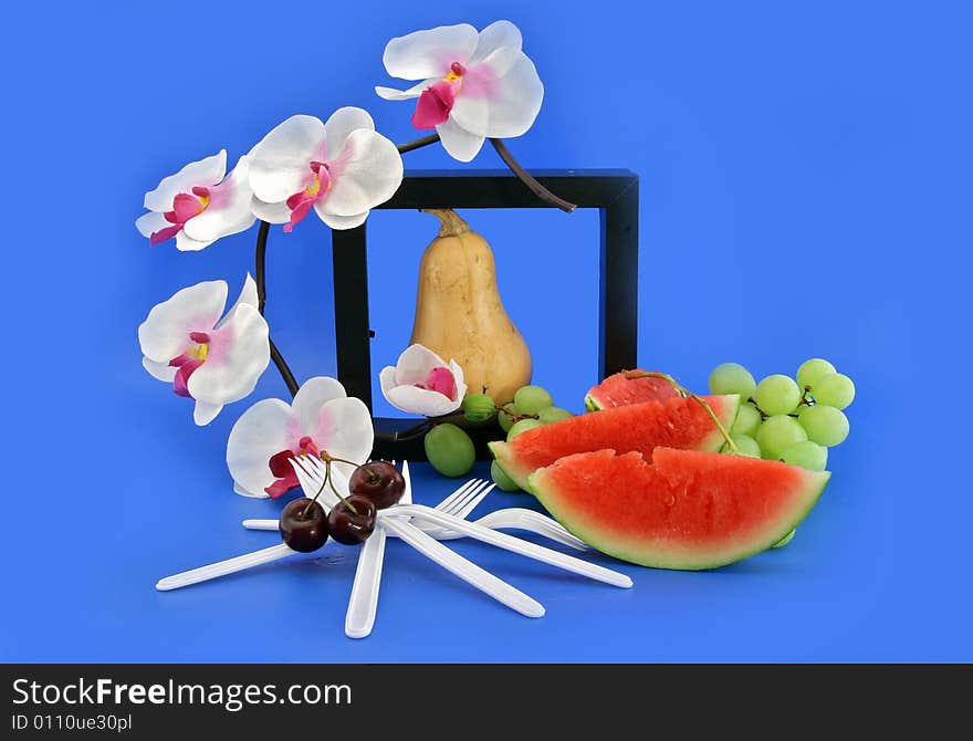 Composition from fruit and a white orchid. Composition from fruit and a white orchid