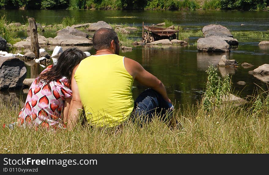 Man with woman on a river-bank. Man with woman on a river-bank