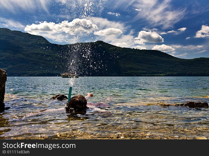 Snorkeling in a clear lake with water pouring. Snorkeling in a clear lake with water pouring