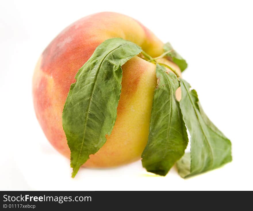 Peach with leafs isolated on white