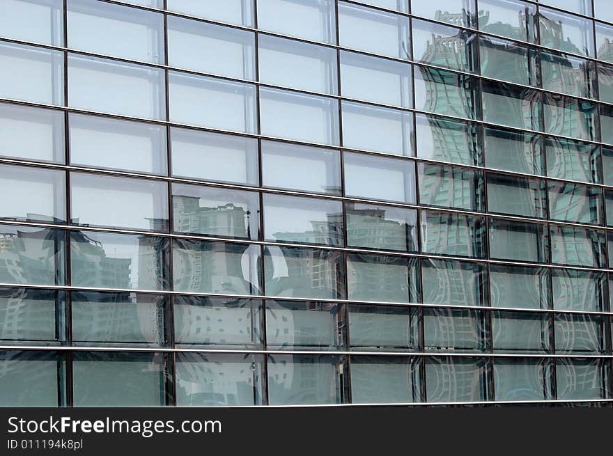 China, modern Chinese skyscrapers close photos - visable windows, glass panels, reflections, walls. China, modern Chinese skyscrapers close photos - visable windows, glass panels, reflections, walls.