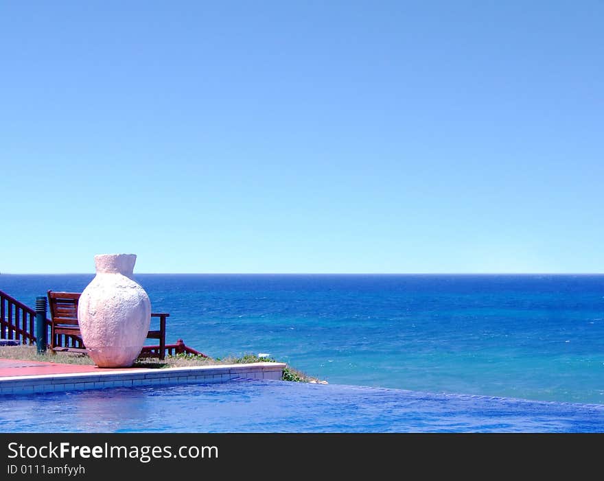 Pool with a sea view and white pot. Pool with a sea view and white pot