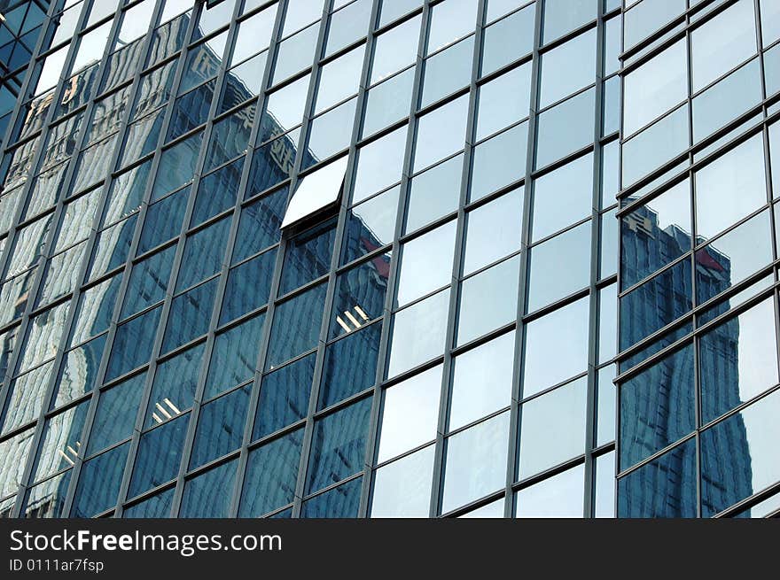 China, modern Chinese skyscrapers close photos - visable windows, glass panels, reflections, walls. China, modern Chinese skyscrapers close photos - visable windows, glass panels, reflections, walls.