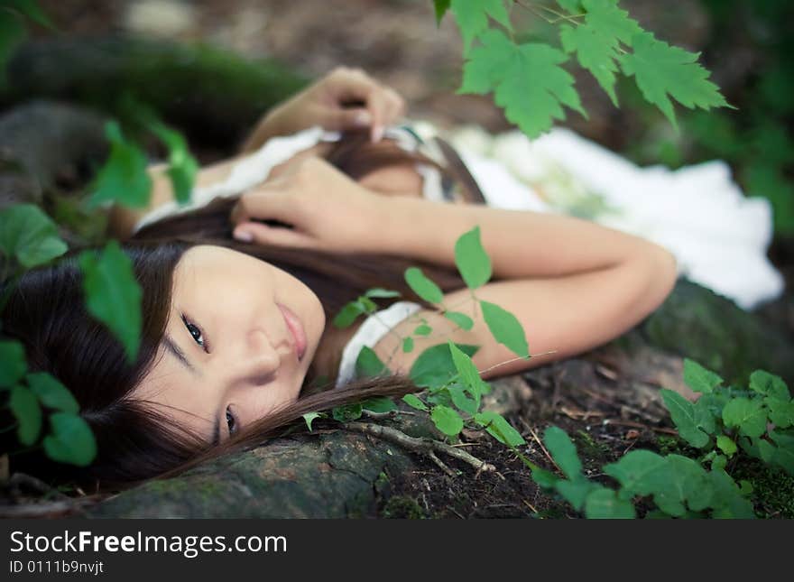 Beautiful asiatic girl dreaming in forest. Beautiful asiatic girl dreaming in forest