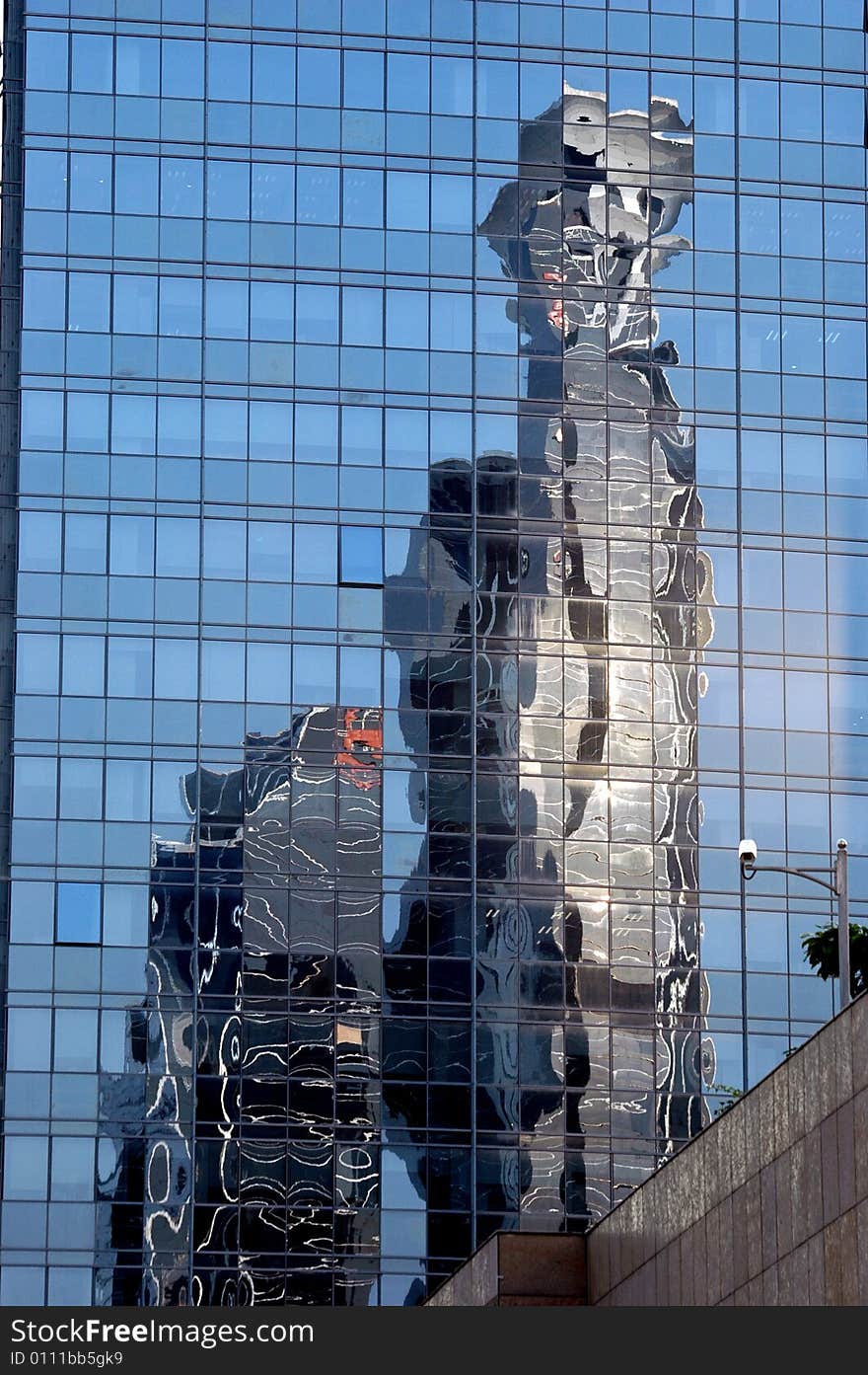 China, modern Chinese skyscrapers close photo showing reflection of another building in glass panels. China, modern Chinese skyscrapers close photo showing reflection of another building in glass panels.