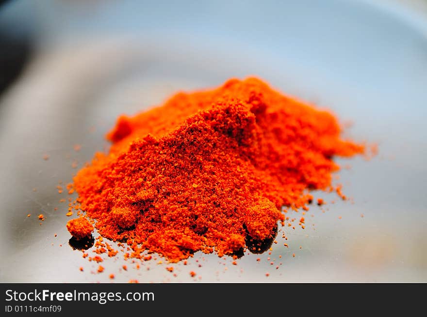 Sweet paprika powder on a black desk, with very vivid red color