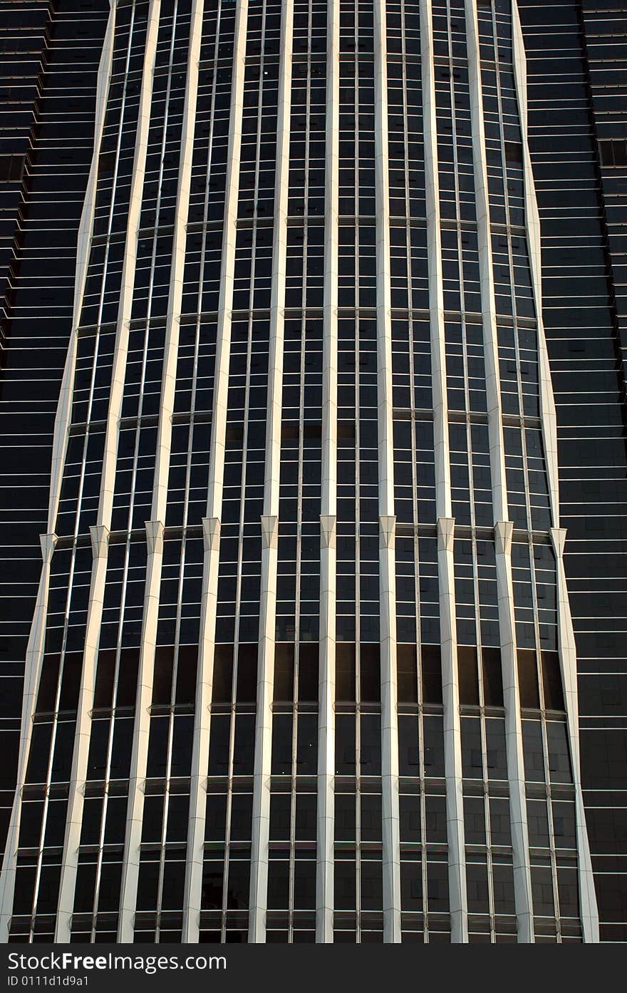 China, modern Chinese skyscraper close photo of front wall, all made of black glass panels. China, modern Chinese skyscraper close photo of front wall, all made of black glass panels.