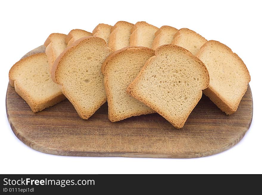 Pieces of toast on a wooden hardboard