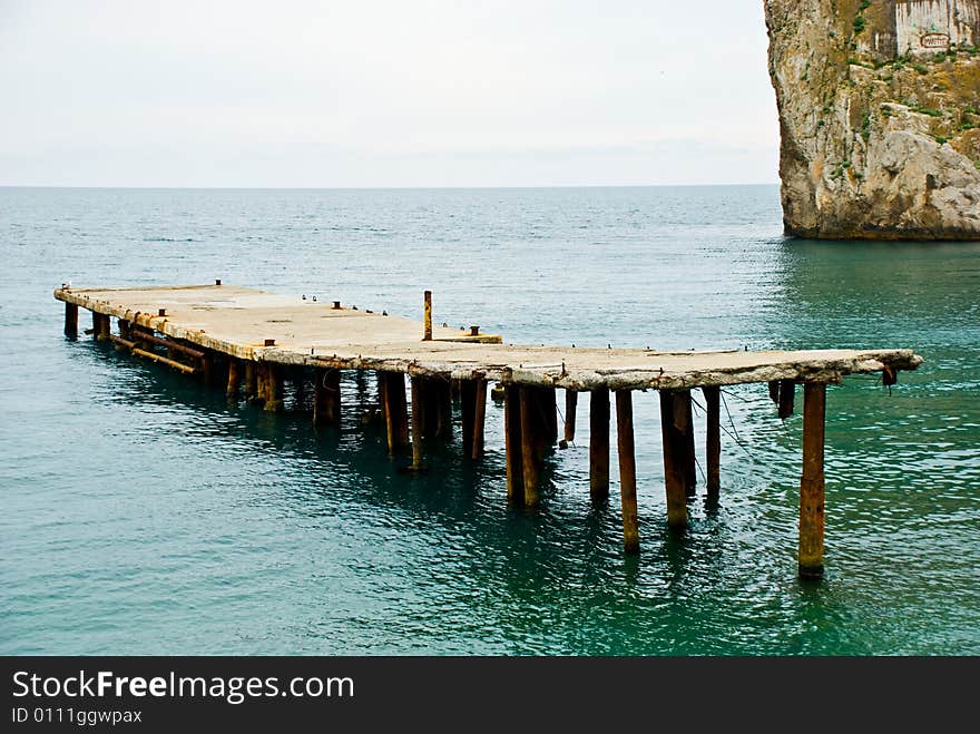 Long pier at summer sea. Long pier at summer sea