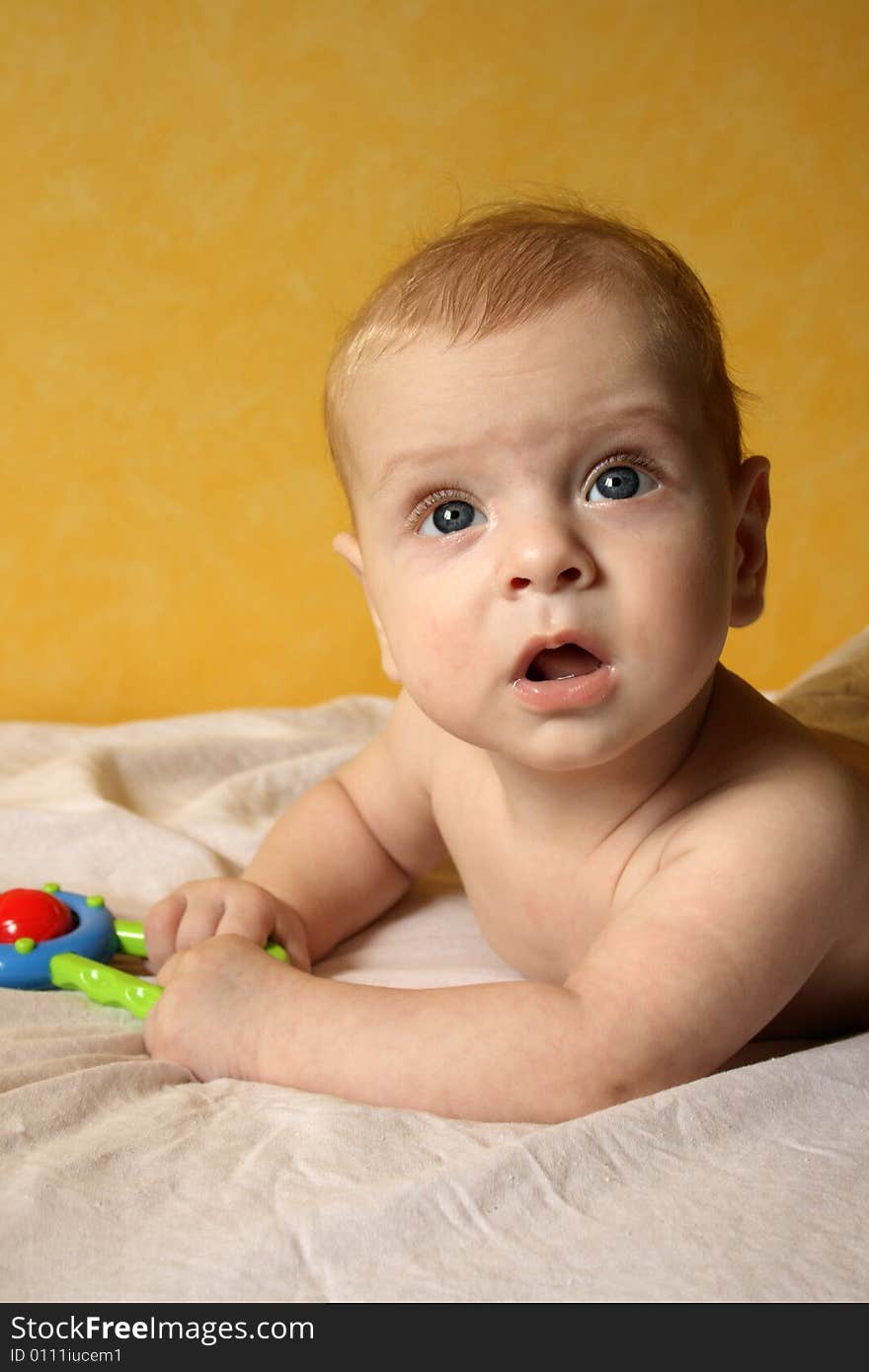 Clouse-up portret of baby boy on yellow background