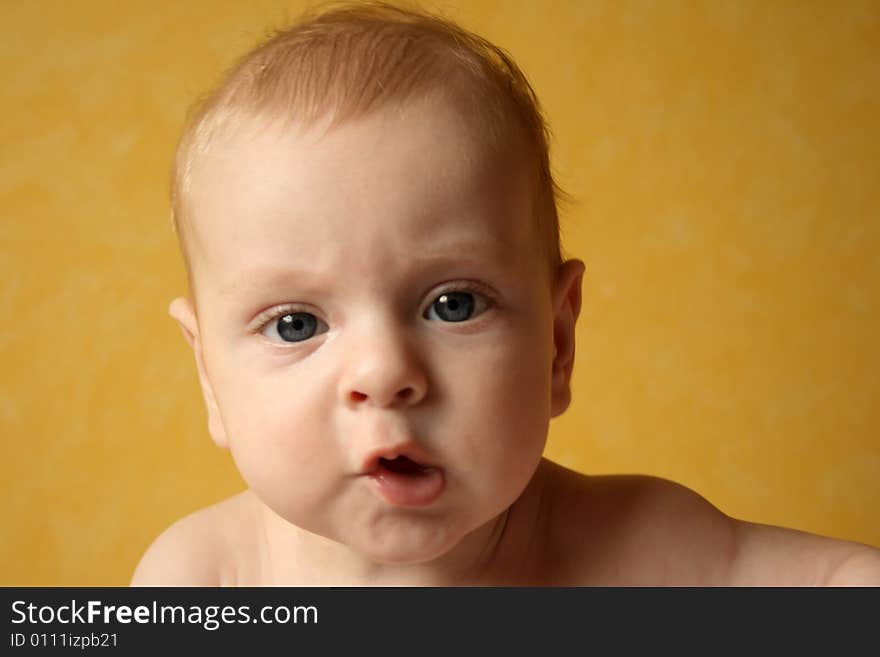 Baby boy on yellow background