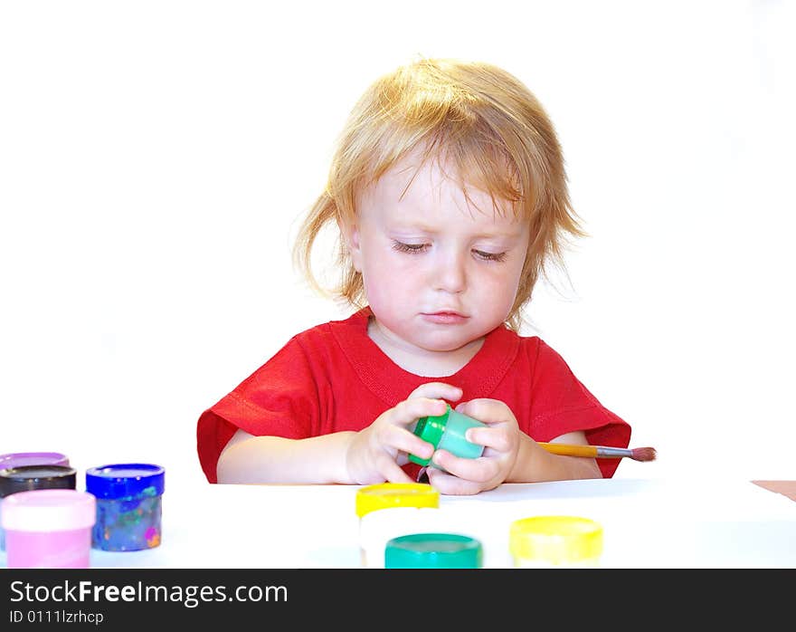 Little girl and paints isolated on white background