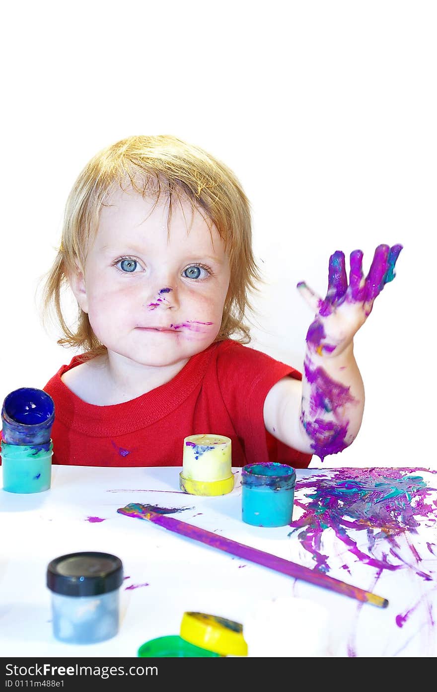 Little girl draws on a table isolated. Little girl draws on a table isolated