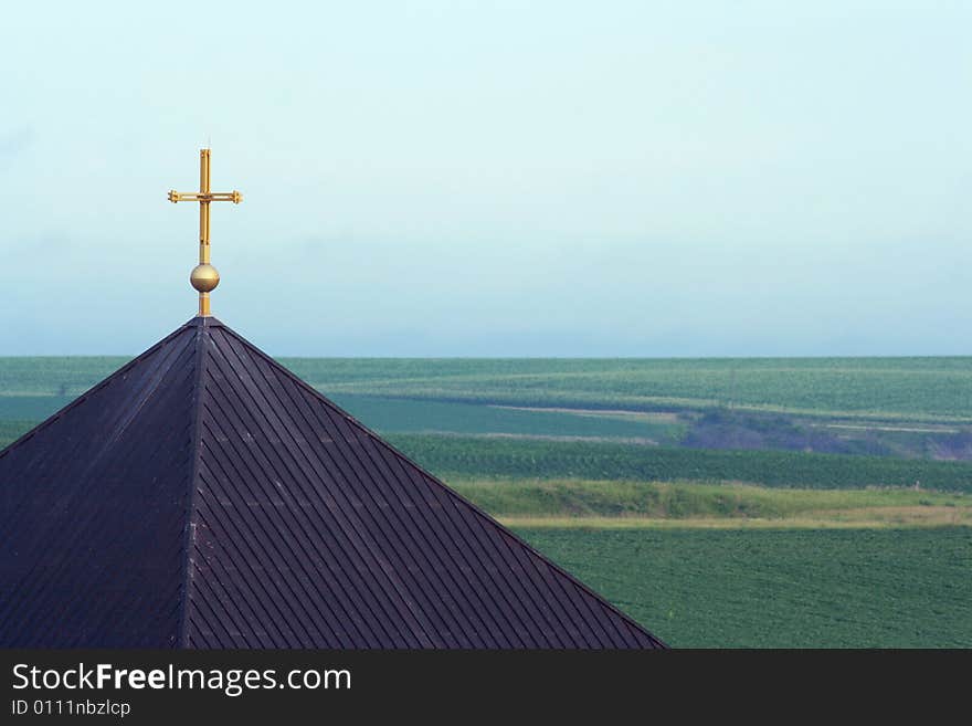 Cross and roof on St. Benedict Retreat Center; Schuyler, Nebraska; rural landscape. Cross and roof on St. Benedict Retreat Center; Schuyler, Nebraska; rural landscape