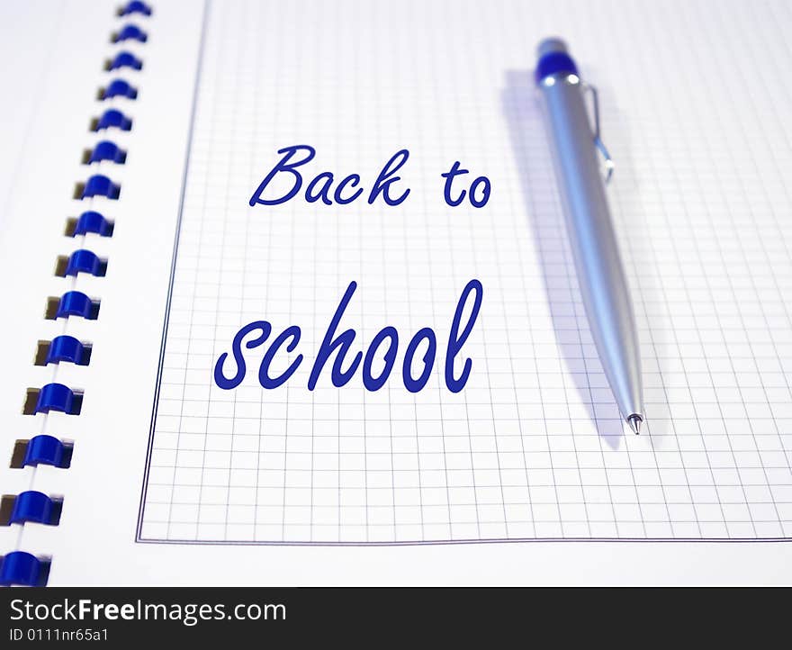 One silver pen and spiral notebook closeup. One silver pen and spiral notebook closeup