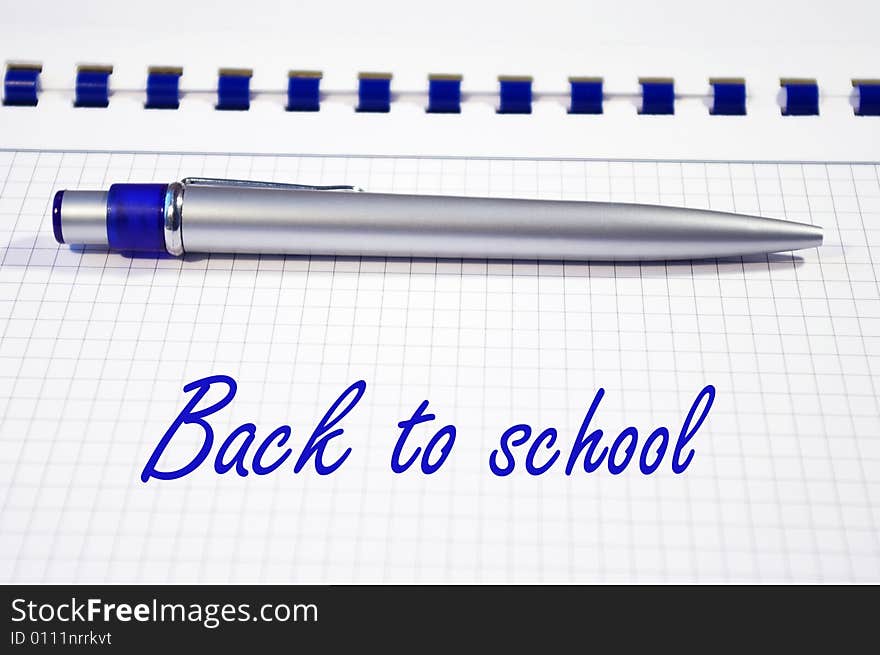 One silver pen and spiral notebook closeup. One silver pen and spiral notebook closeup