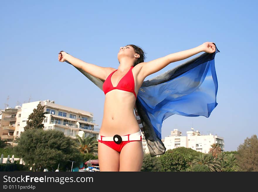 Pretty girl with pareo on the beach.