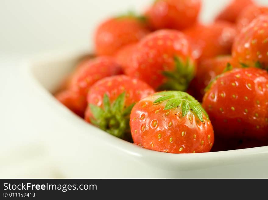 Strawberry in white bowl on white background. Strawberry in white bowl on white background