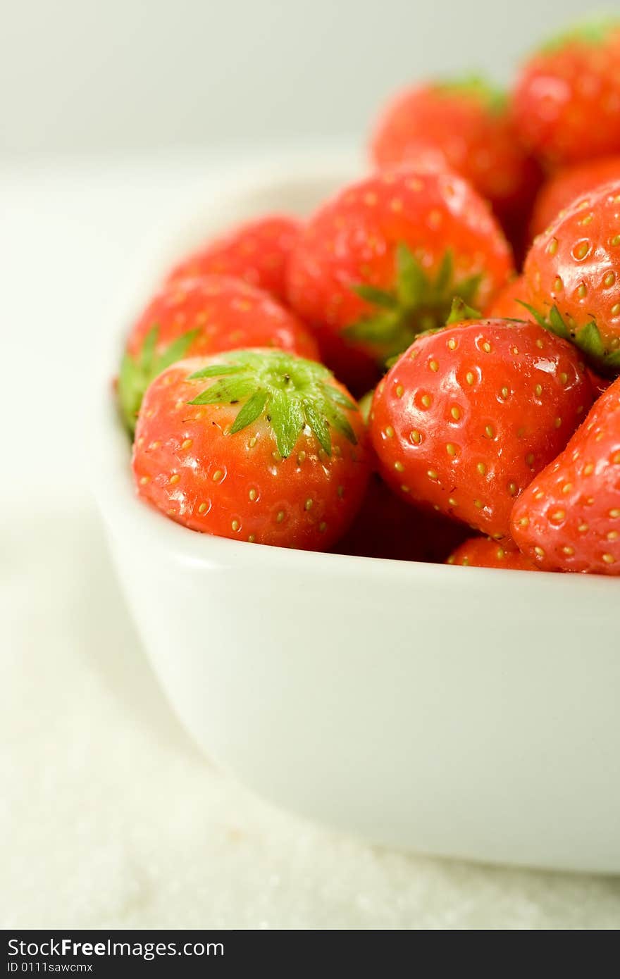 Strawberry in white bowl on white background. Strawberry in white bowl on white background