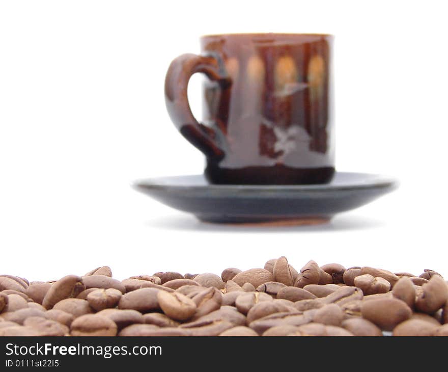 Coffee beans and cup on white background