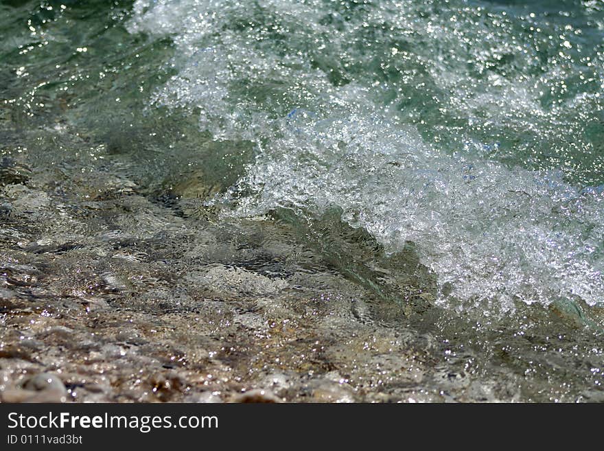 Waves and pebbles at a seashore