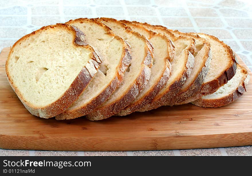 Fresh sliced Italian bread on a cutting board. Fresh sliced Italian bread on a cutting board.