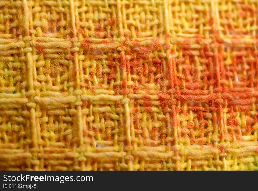 Macro pattern of colorful ( yellow, orange, red ) textile fabric