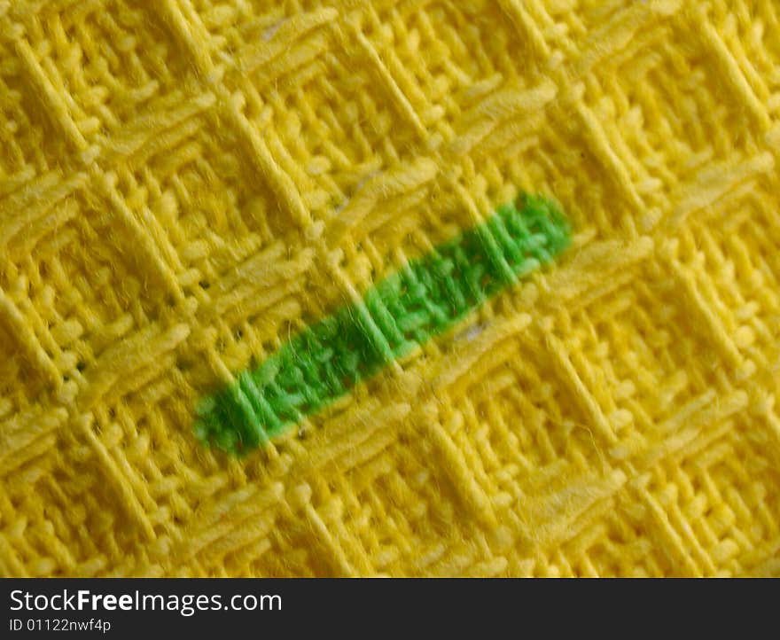 Macro pattern of yellow textile fabric with green strip