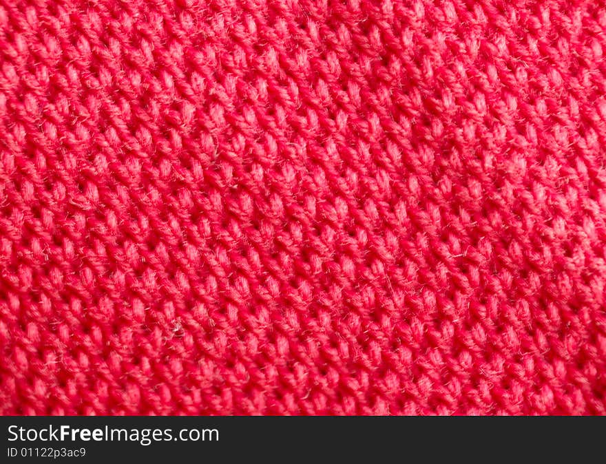 Macro pattern of red textile fabric .