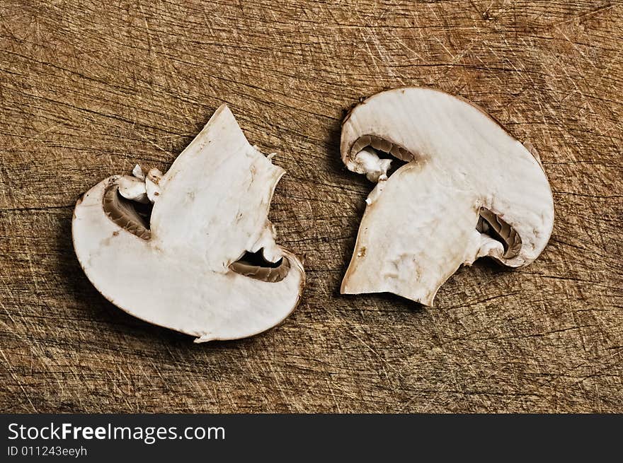 Two champignons on cutting table, close up shot.