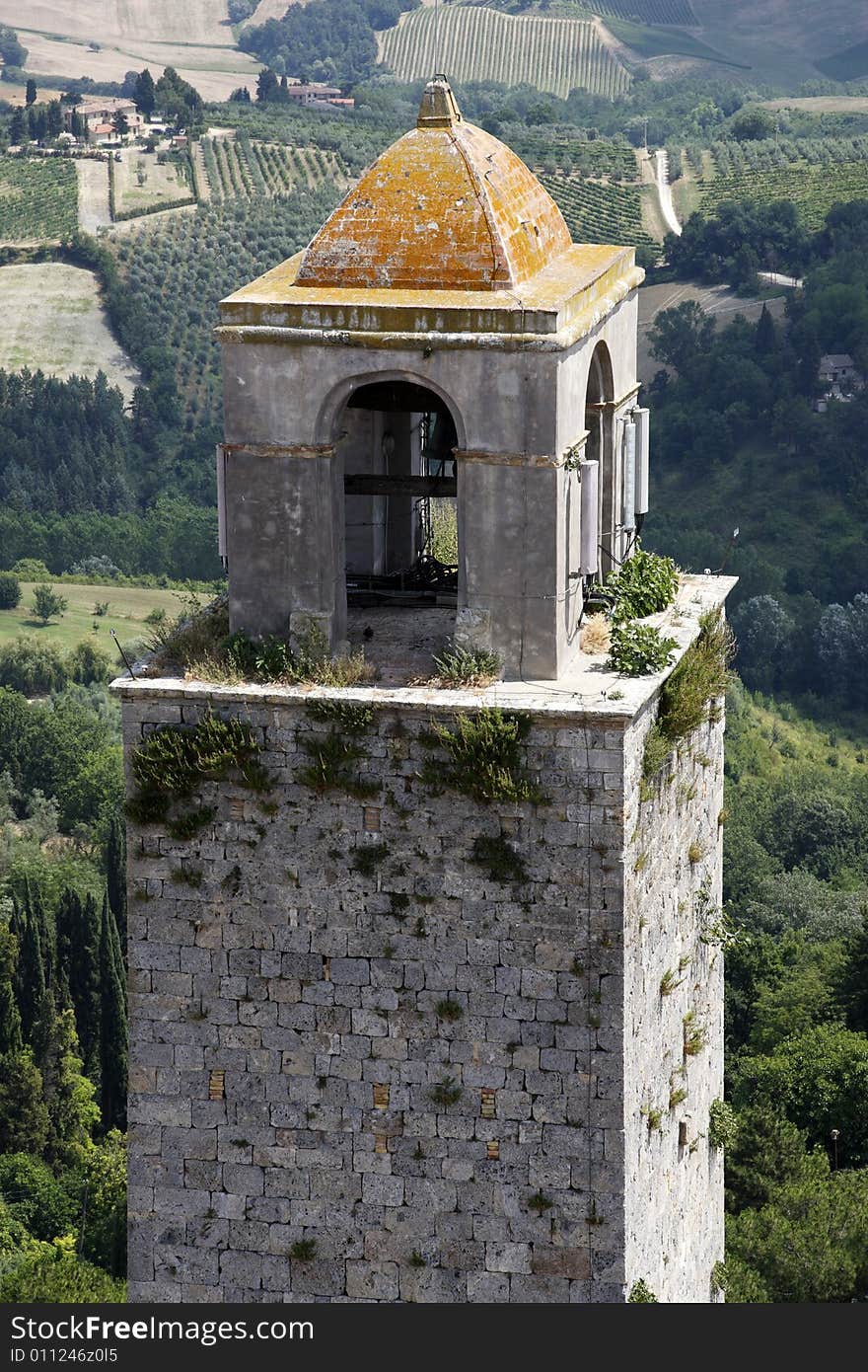 Top of the bell tower with the rolling tuscany countryside beyond from the torre grossa san gimignano tuscany italy europe