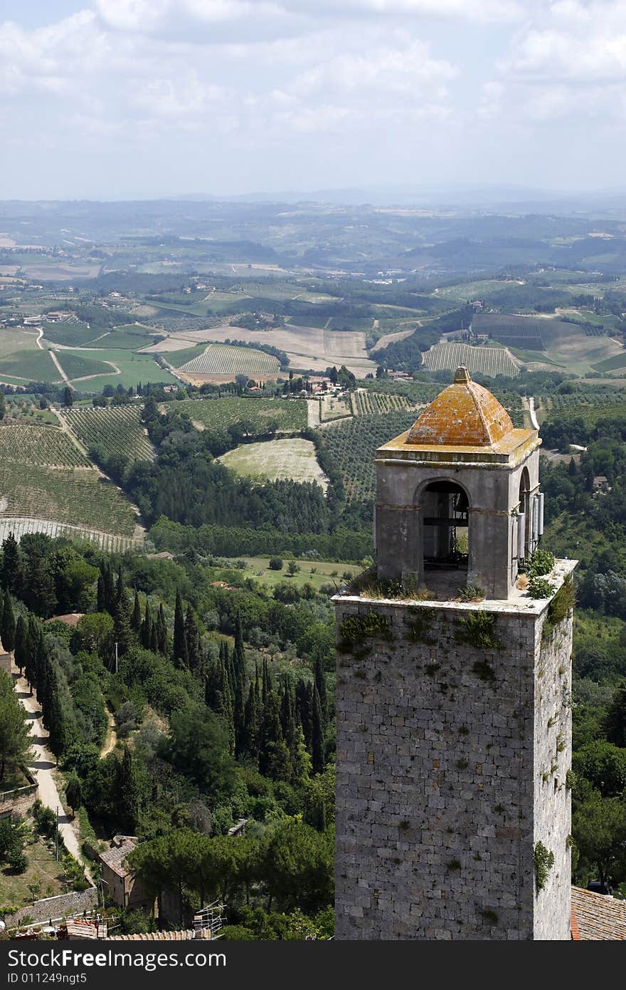 Top of the bell tower with the rolling tuscany countryside beyond from the torre grossa san gimignano tuscany italy europe