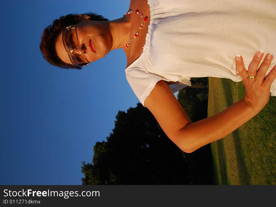 Girl in garden looks at sky by early morning