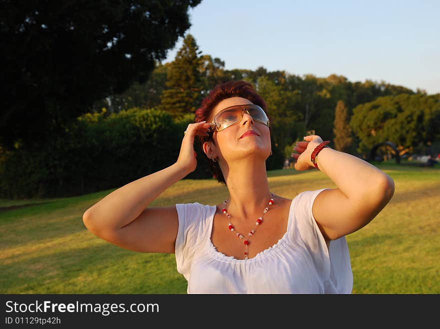 Girl in garden looks at sky by early morning