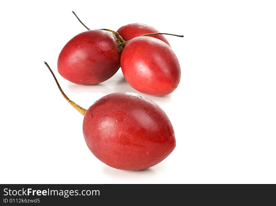 Fresh red tamarillo fruit with cool water droplets. Fresh red tamarillo fruit with cool water droplets