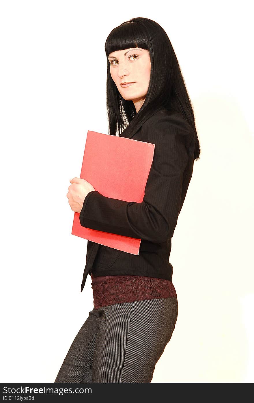 A young pretty businesswoman standing in a studio with a red 
folder in her hand. A young pretty businesswoman standing in a studio with a red 
folder in her hand.