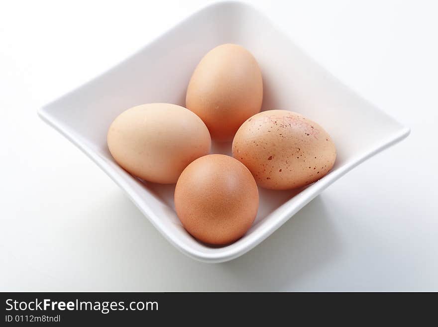 Four eggs in a white bowl