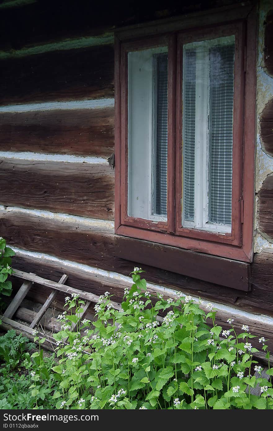 Old wooden village house, window detail. Old wooden village house, window detail