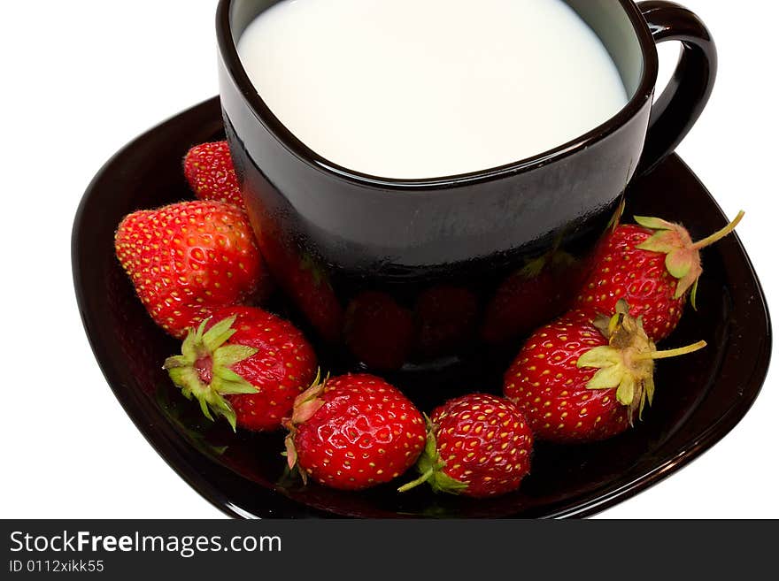 Black cup of milk and strawberries, isolated on white