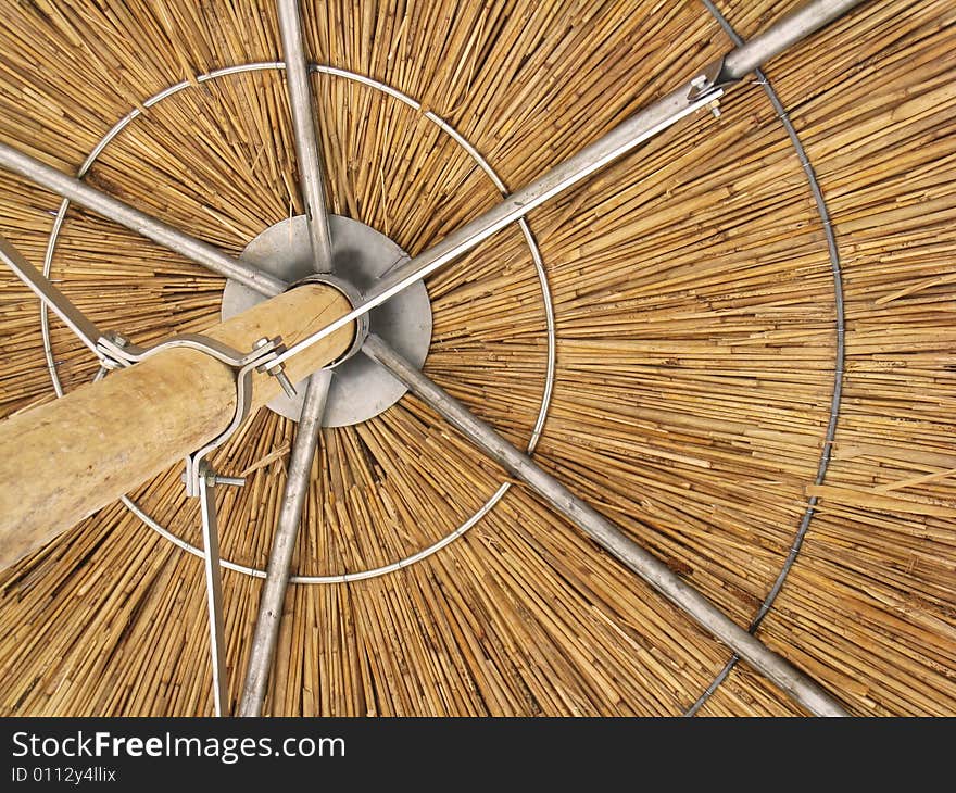 Detail of round straw umbrella for summer shade