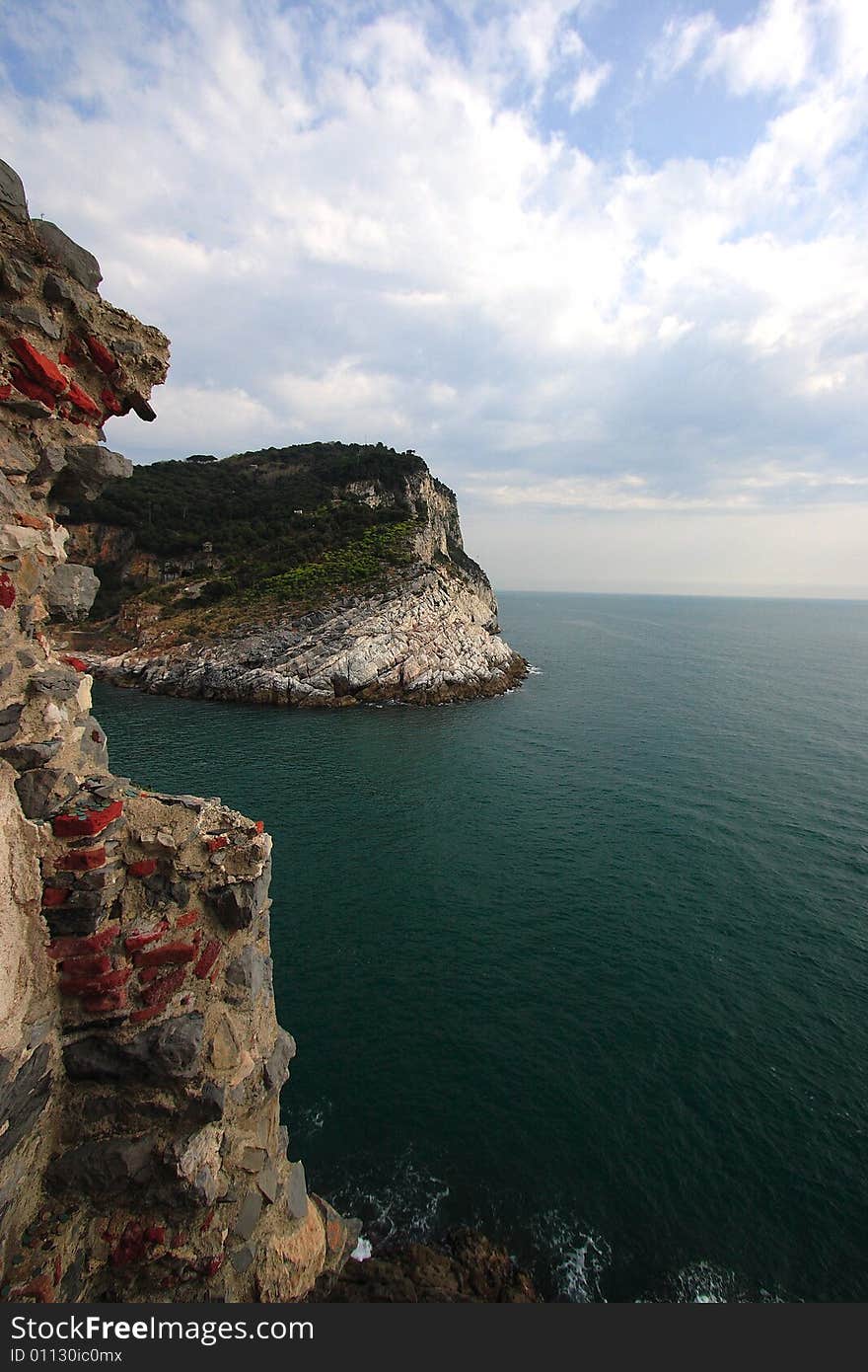 Fishing boats on a harbor with the seafront view of Portovenere in Italy.